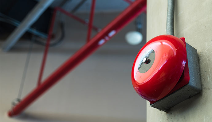 Circular fire alarm bell on a wall