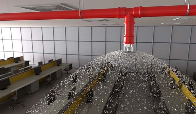 Fire sprinkler head spraying water in office
