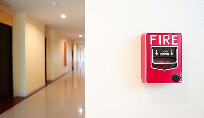 Indoor fire alarm pull station in hallway